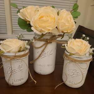 Set of three painted mason jars with flowers